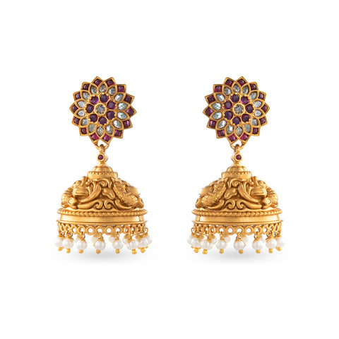 gold platted jhumkas with green crystals and milk white motis