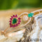 rose gold bracelet with pink and green crystals along with white stones